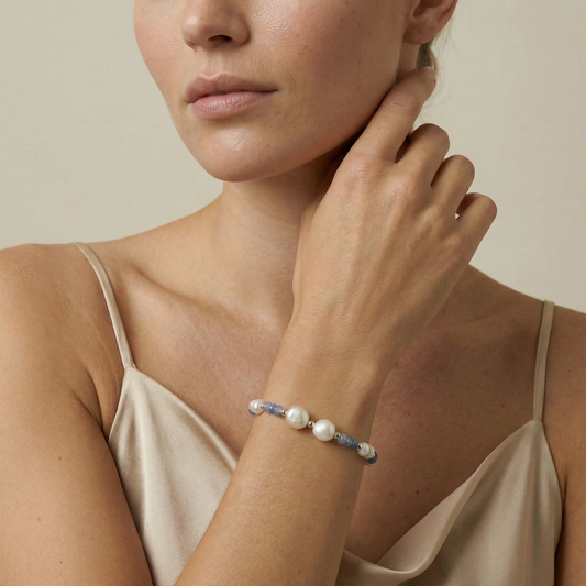 Woman wearing a Blue Aventurine pearl bracelet on a neutral background