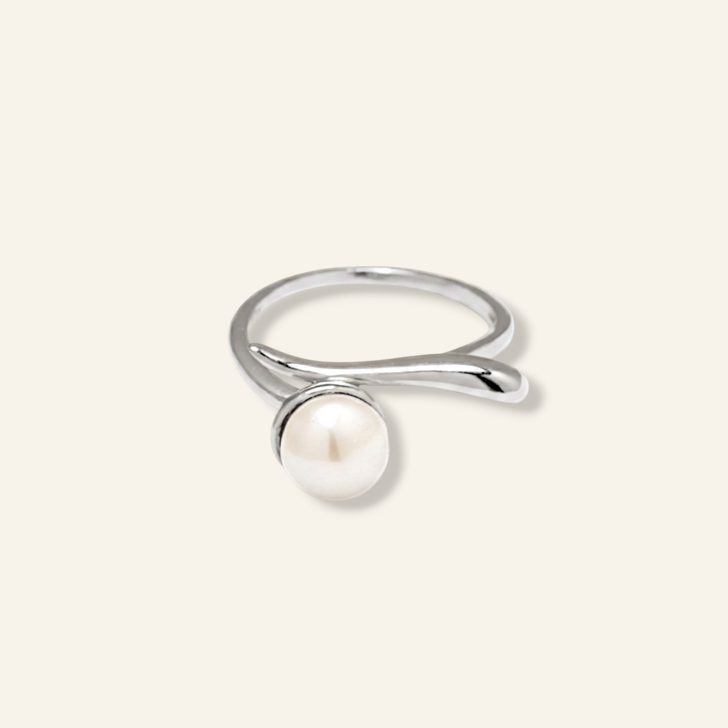 Silver ring with a pearl on a light gray background