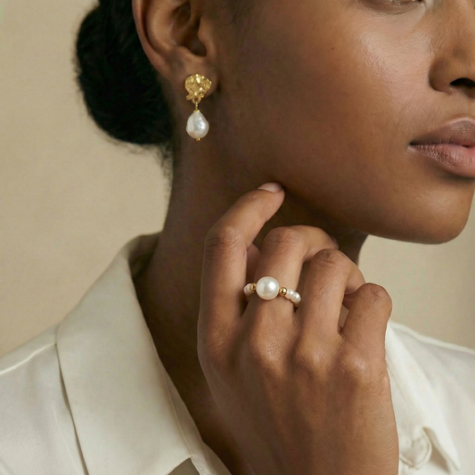 Woman wearing pearl earrings and ring