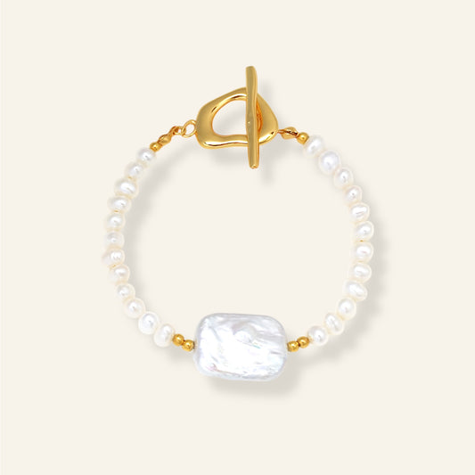 Pearl bracelet with a gold clasp on a white background