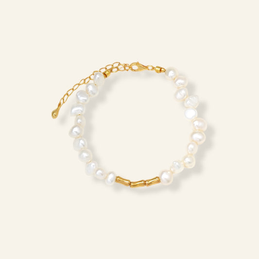 Pearl bracelet with gold chain on a white background