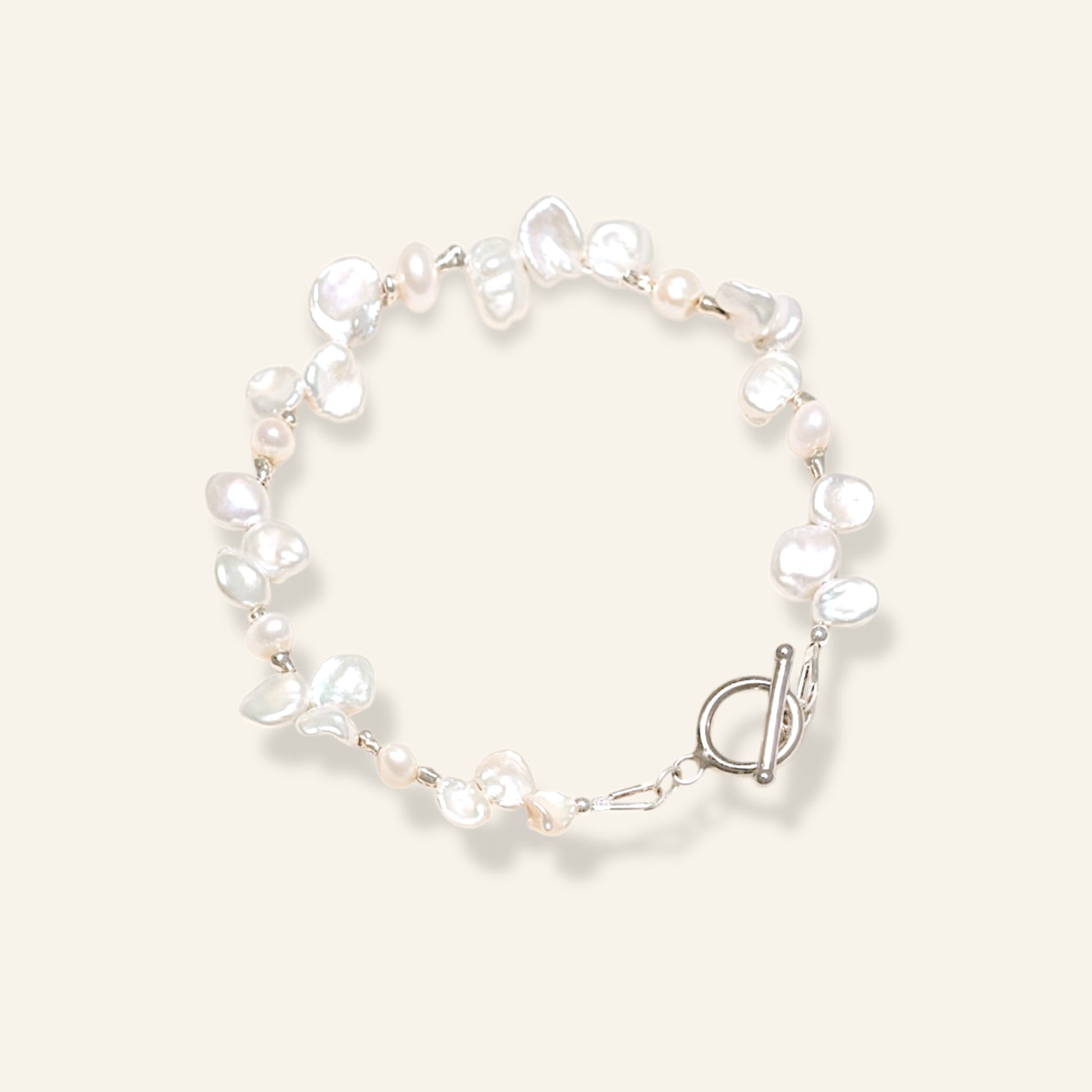 Pearl bracelet with a silver clasp on a light background