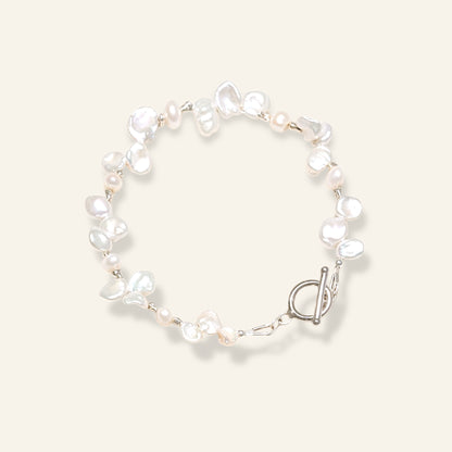 Pearl bracelet with a silver clasp on a light background