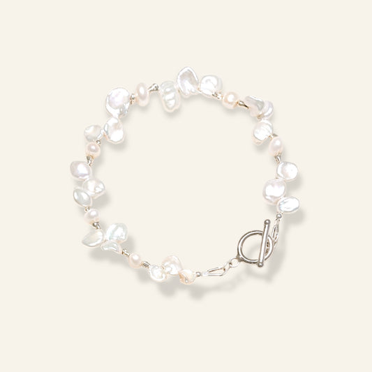Pearl bracelet with a silver clasp on a light background