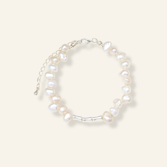 Pearl bracelet on a light gray background