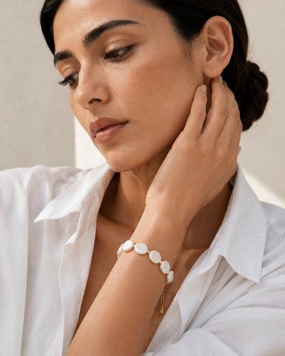 Model wearing the Luna freshwater coin pearl bracelet in gold