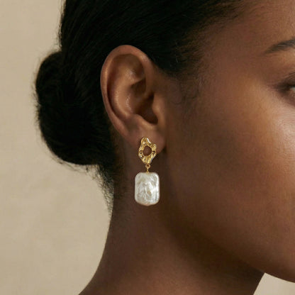 gold earring with a large pearl
