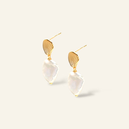 Gold and clear geometric earrings on a white background