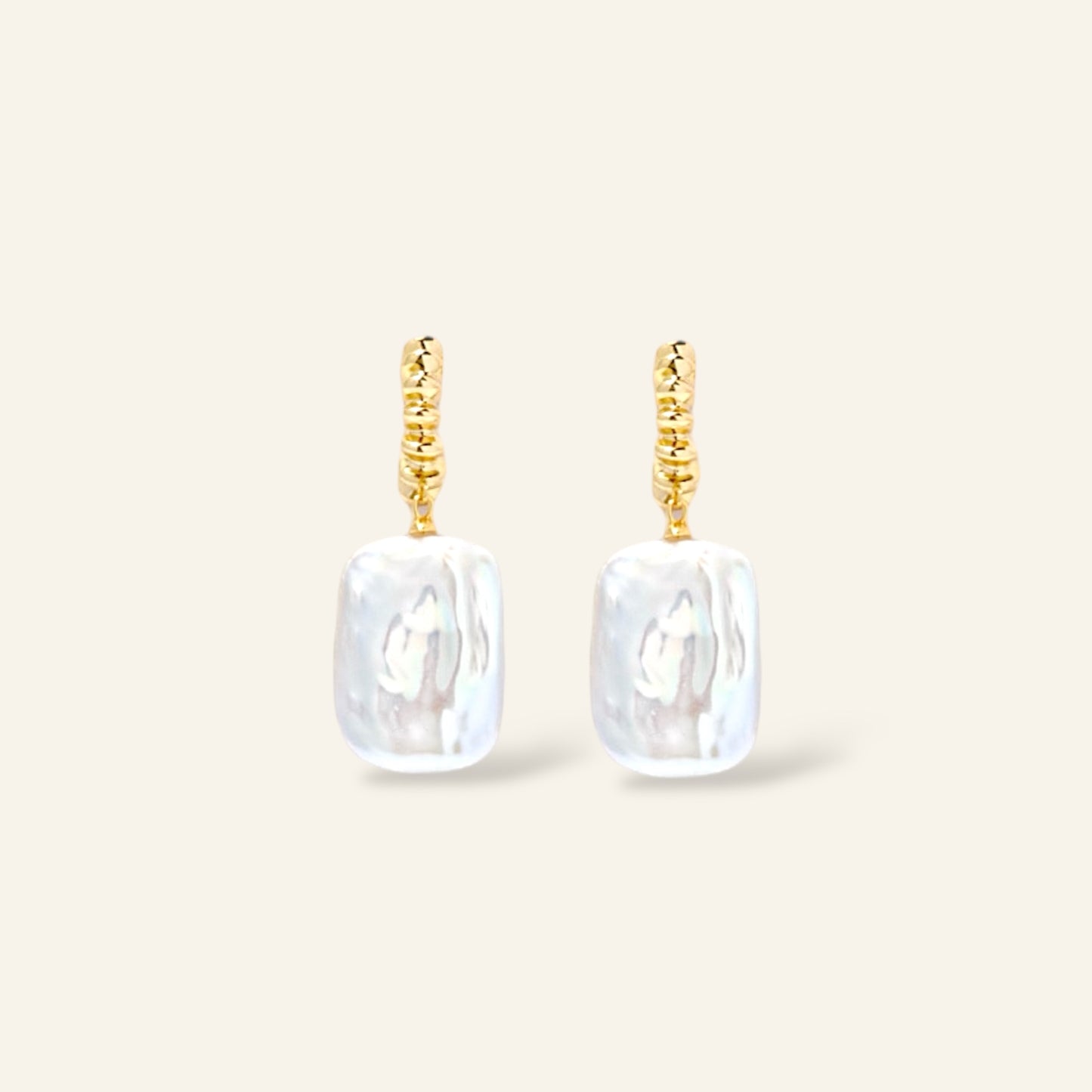 Pair of gold earrings with rectangular white pearl