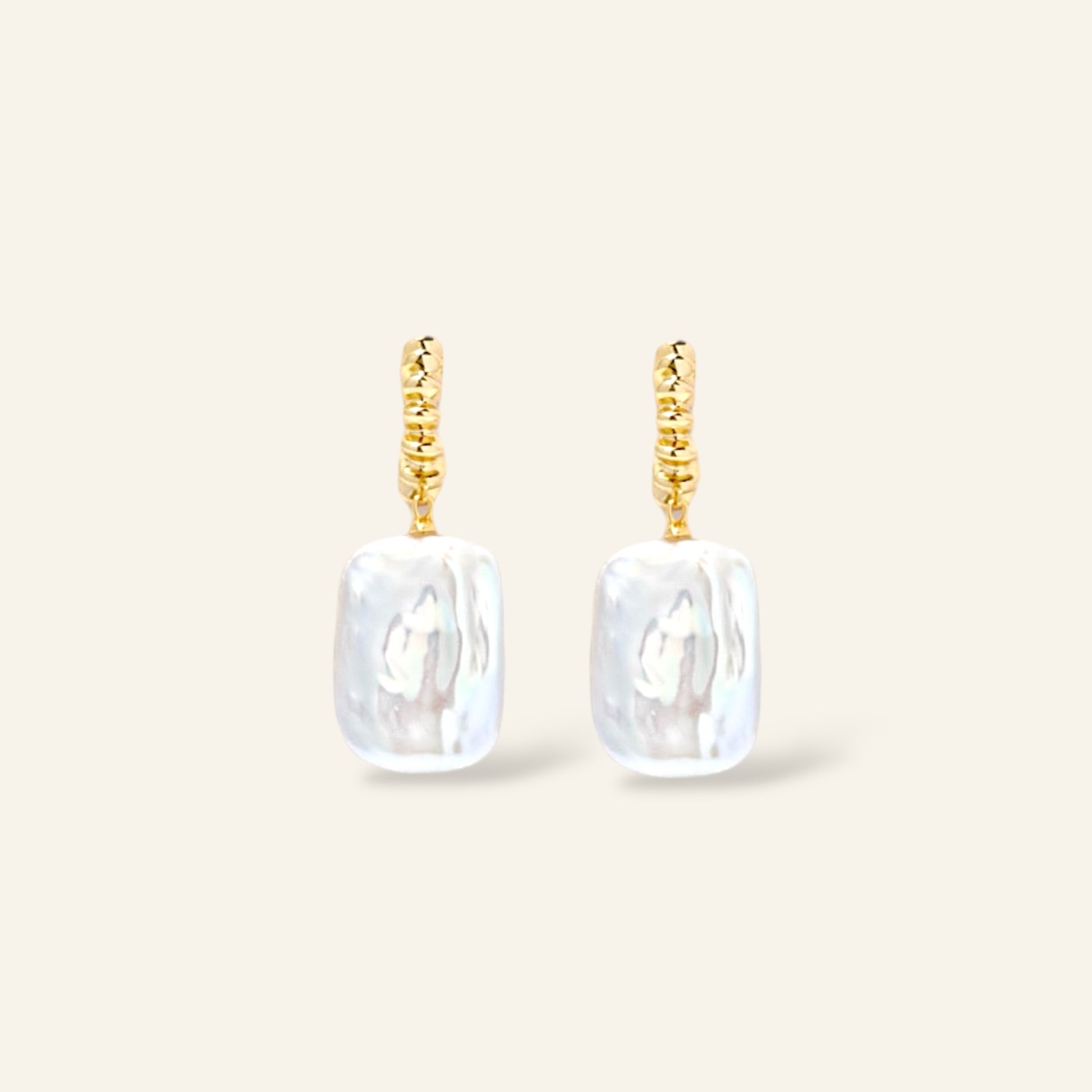 Pair of gold earrings with rectangular white pearl