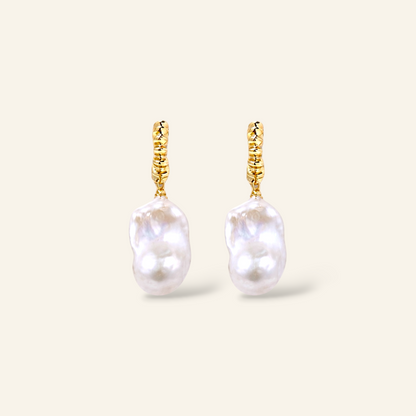 A pair of gold drop earrings featuring baroque freshwater pearl