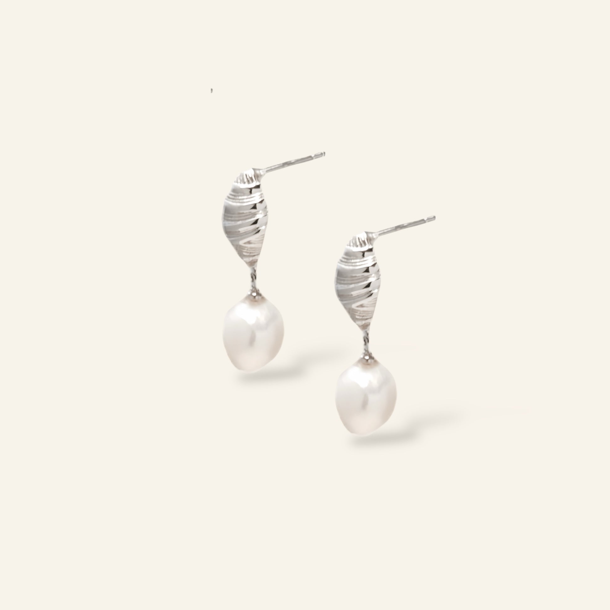 Pair of pearl earrings with silver spiral designs