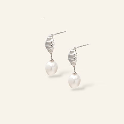 Pair of pearl earrings with silver spiral designs