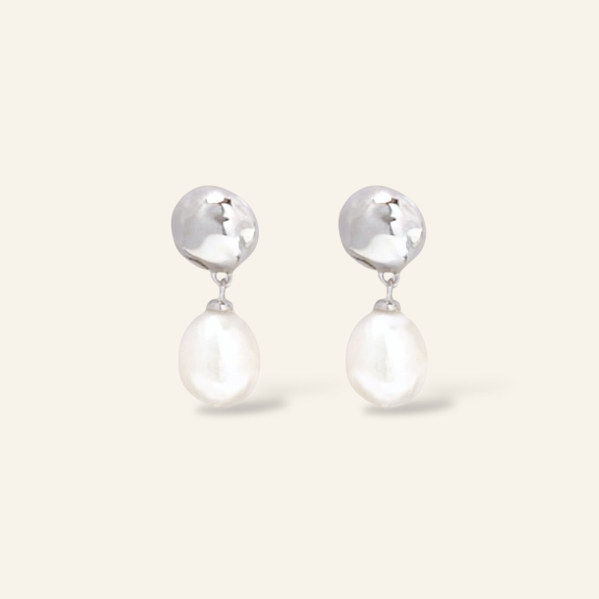 Pair of silver earrings with pearl drops