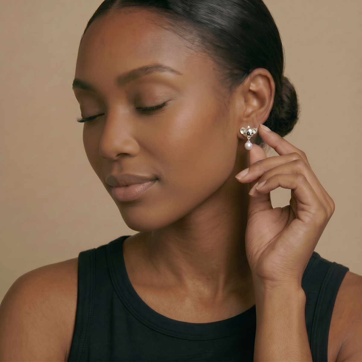 Model wearing Koala pearl drop earrings in silver