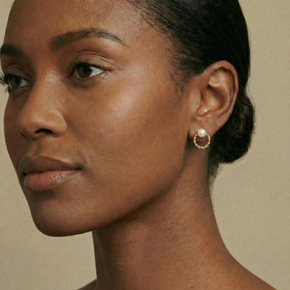 Close-up of a woman wearing a pearl earring 