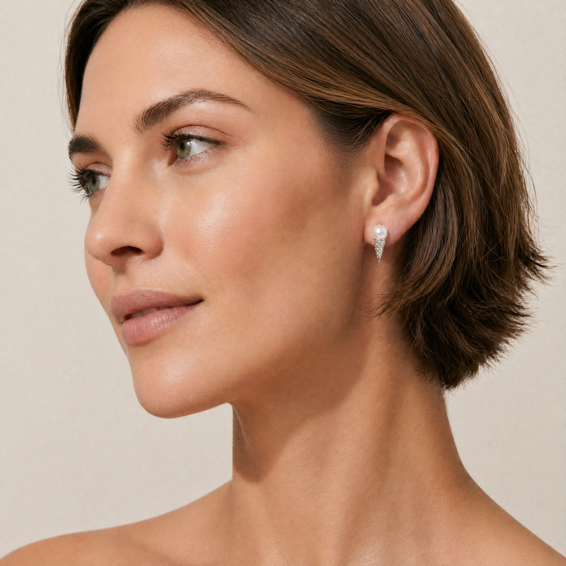 Close-up of a woman wearing a pearl earring