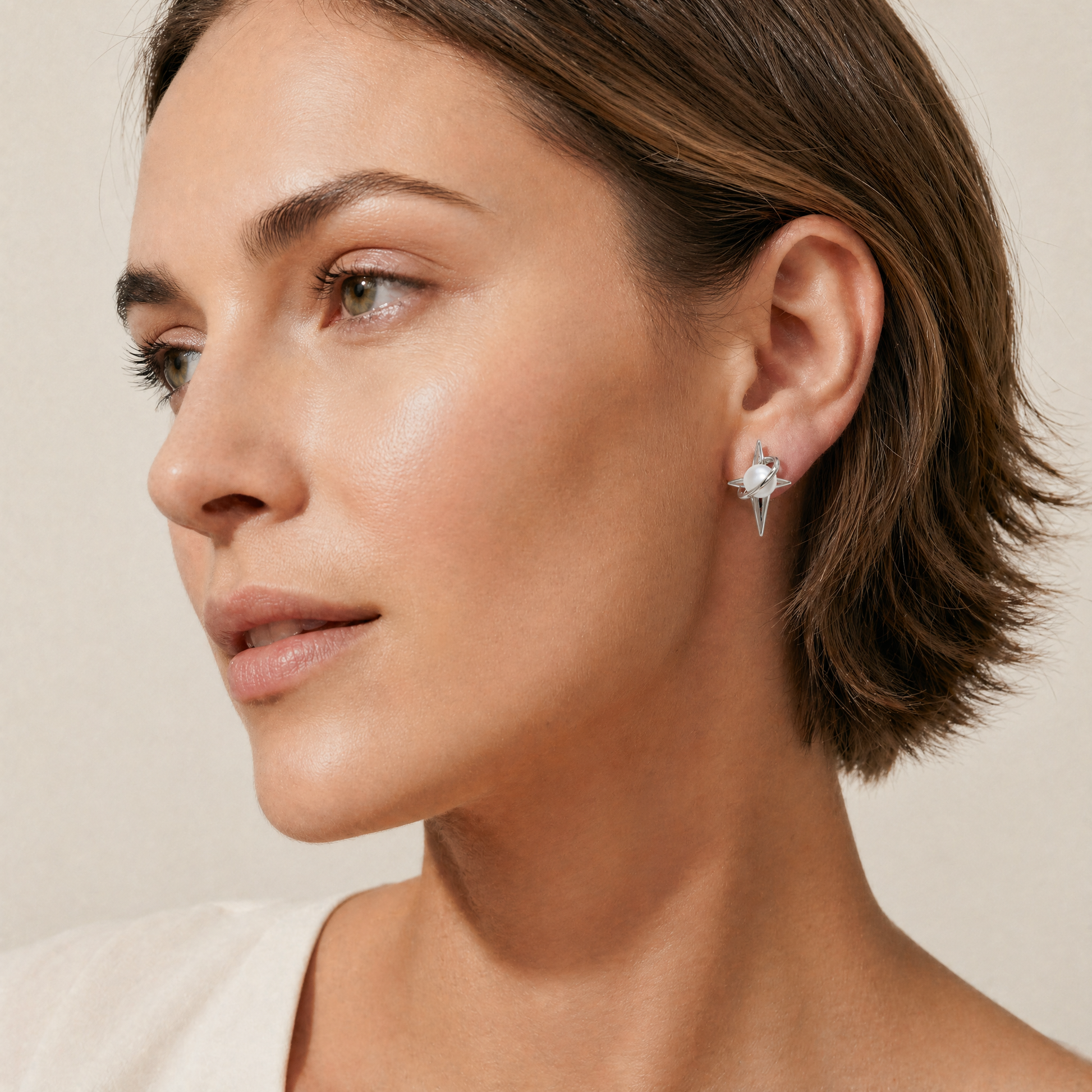 Close-up of a woman wearing a pearl earring 