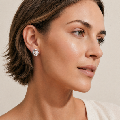 a woman wearing a silver pearl earring 