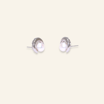 Pair of silver earrings with a pearl center 