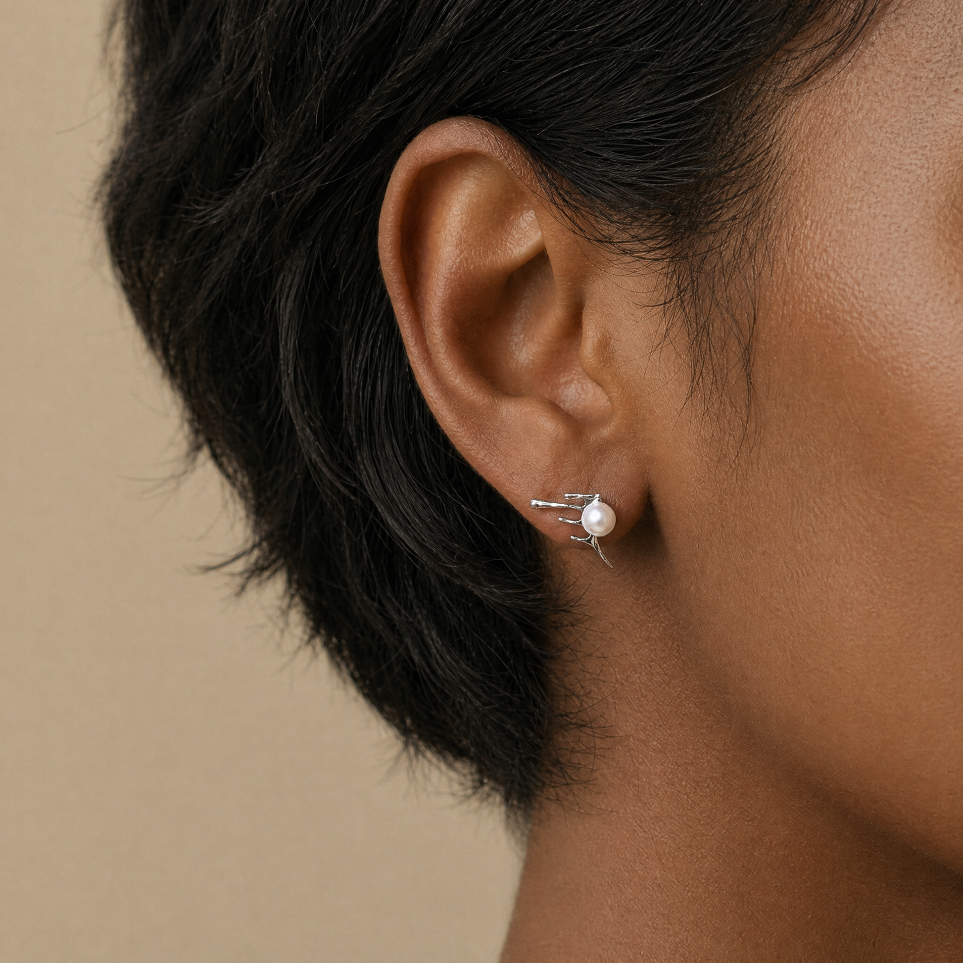 Close-up of an ear wearing a pearl earring 