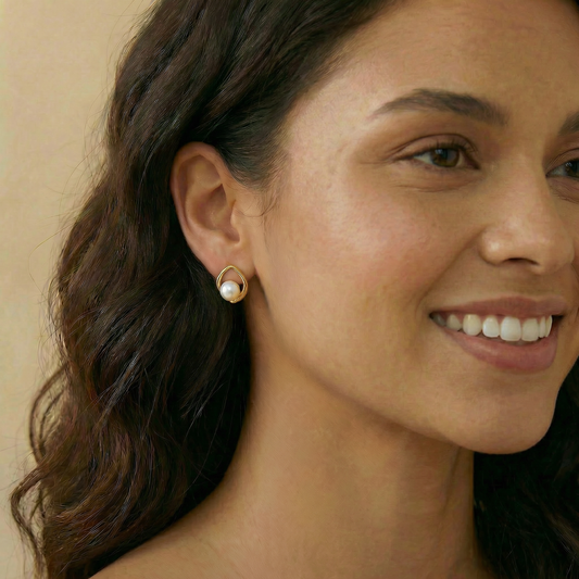 gold earring with a pearl