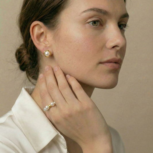 Woman wearing pearl earrings and ring