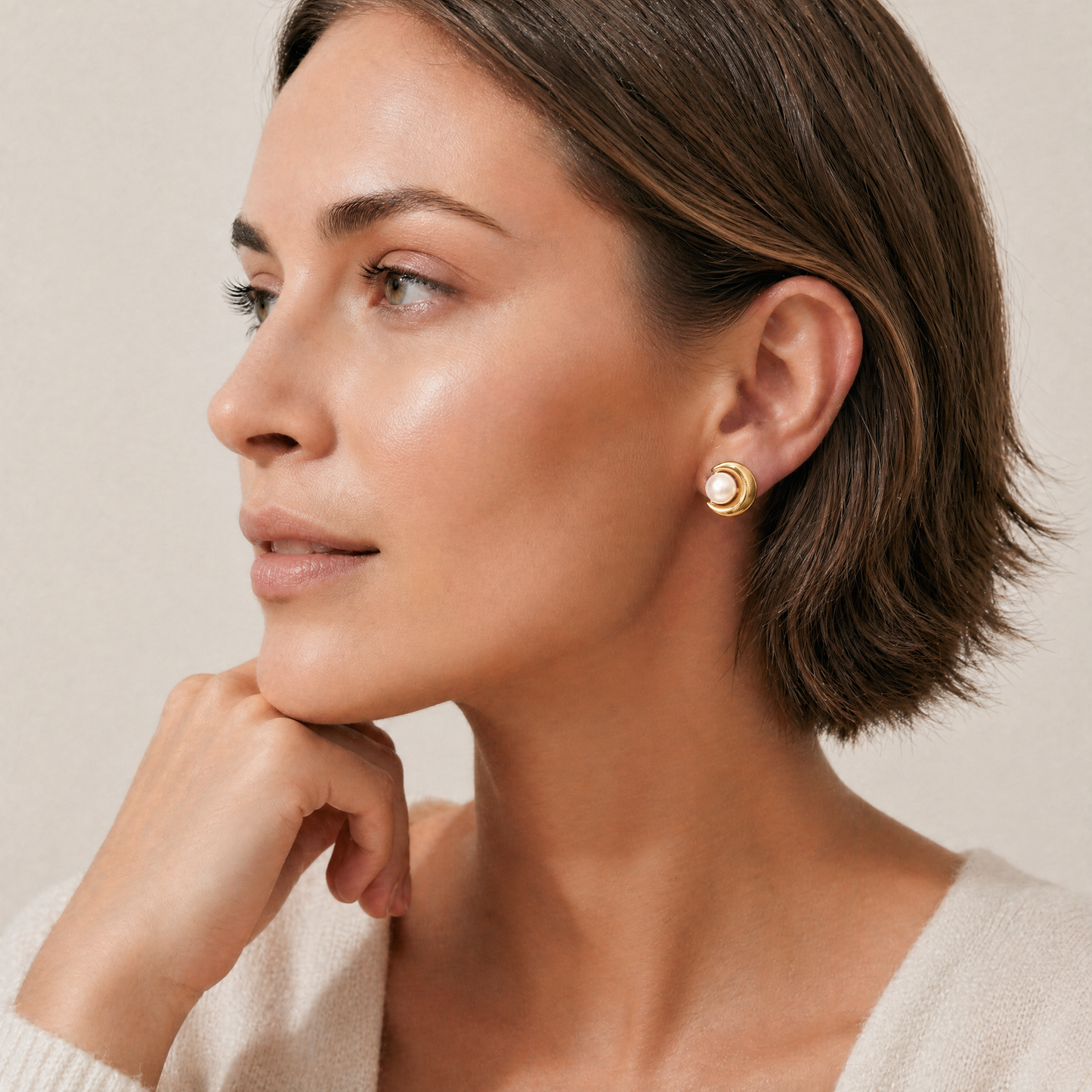 Woman wearing gold freshwater peal earrings 