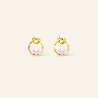 Pair of gold earrings with pearl centers 