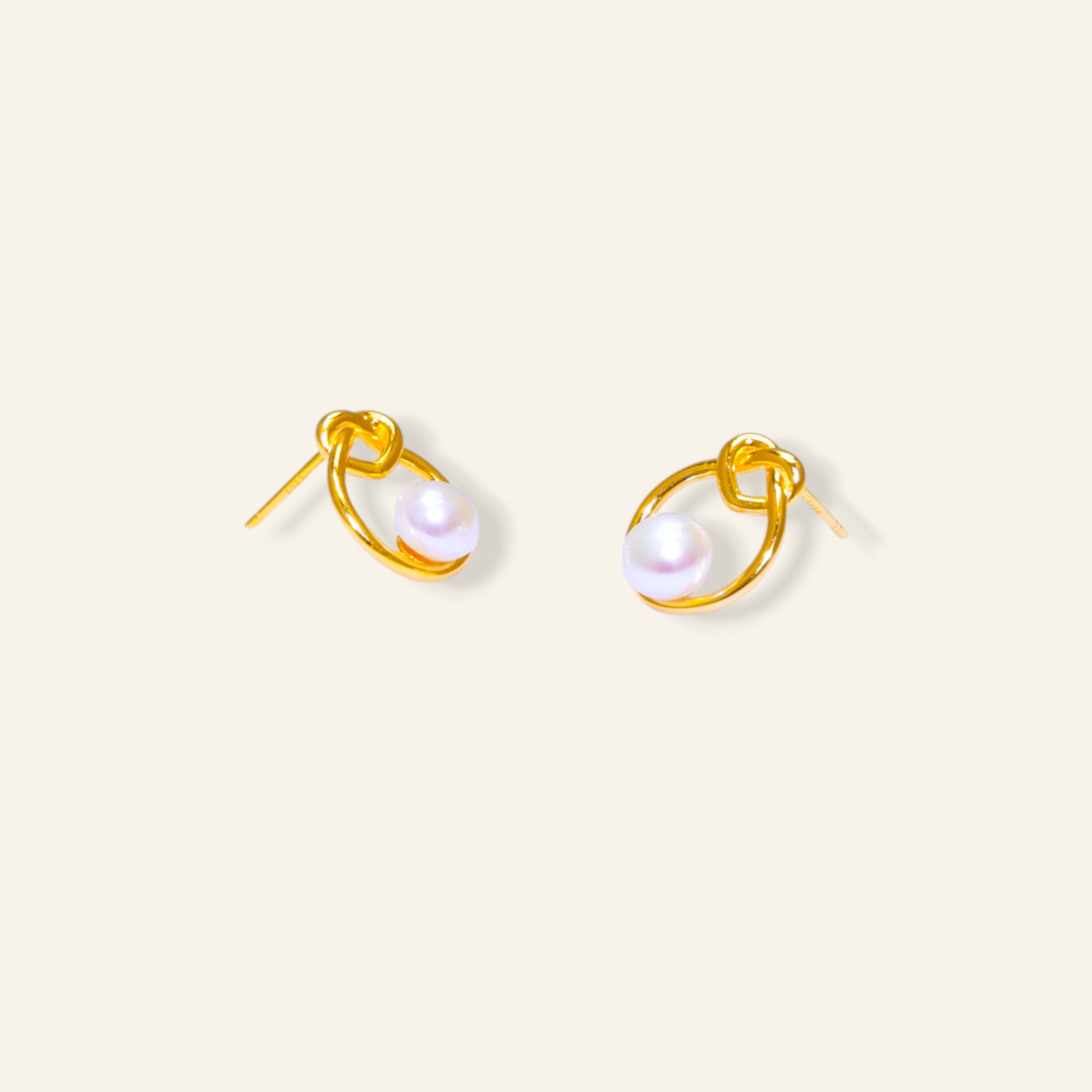 Gold-framed pearl stud earrings