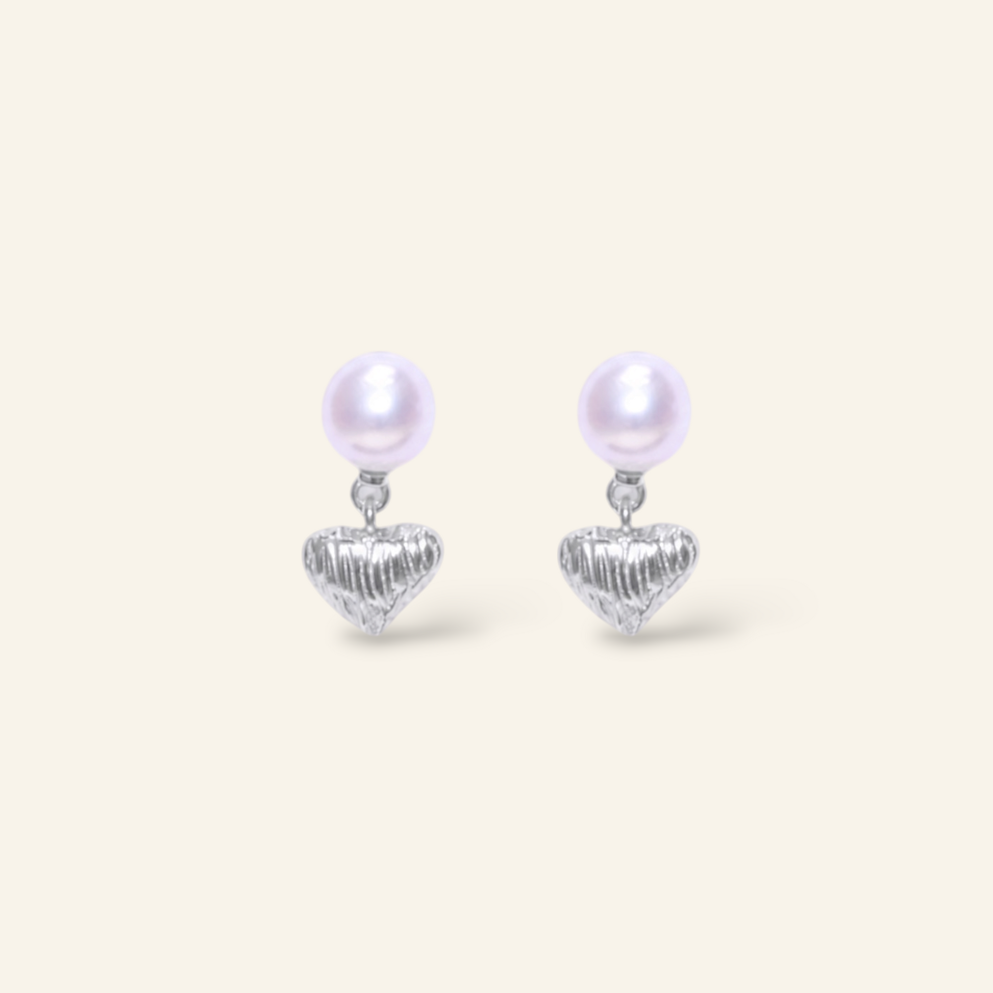 Pair of pearl earrings with heart pendants 
