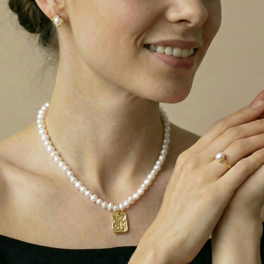 a pearl necklace and ring 