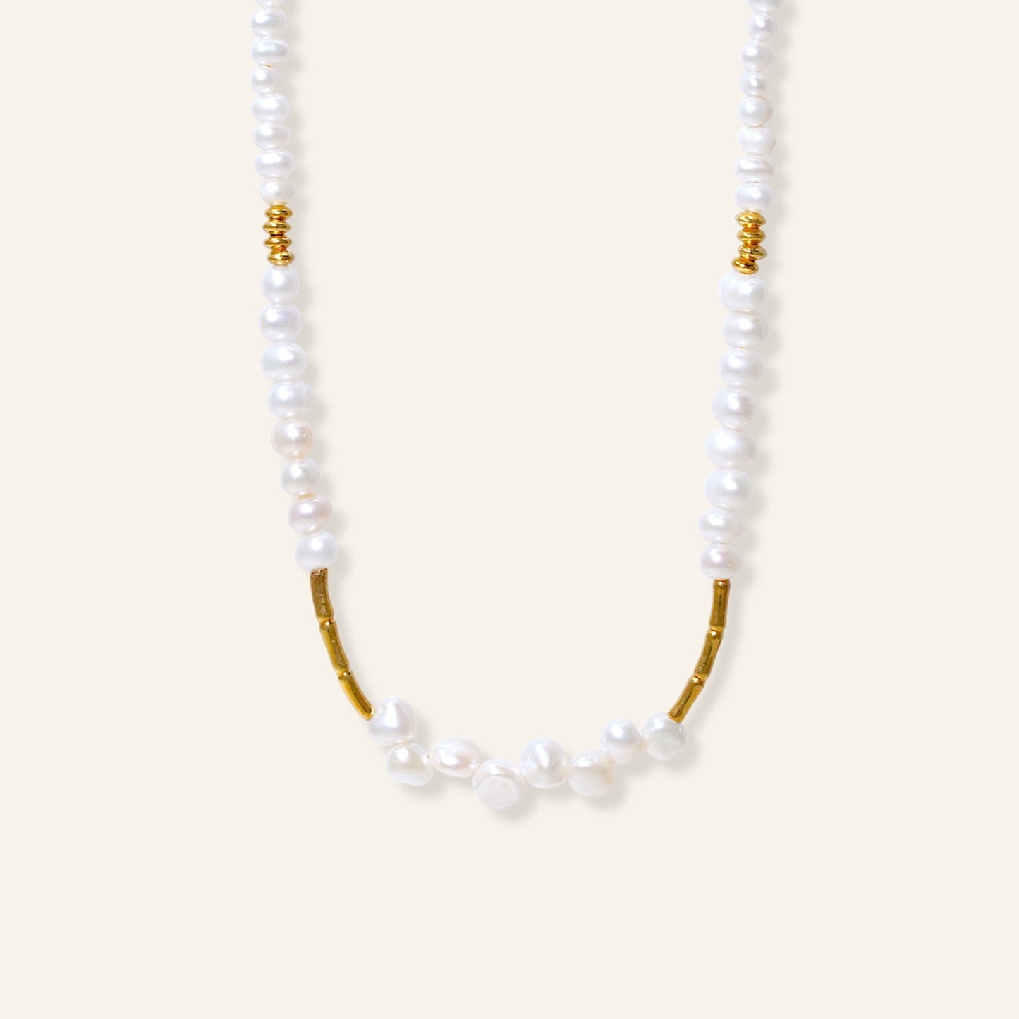 Pearl necklace with gold accents on a white background