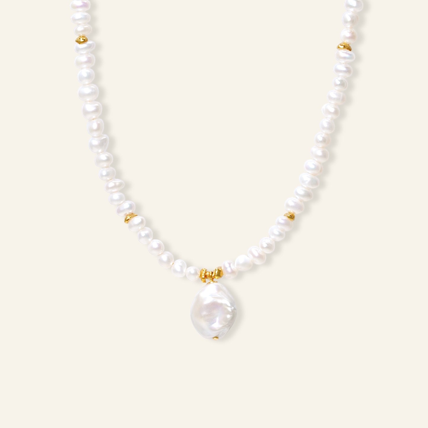 Pearl necklace with gold accents on a white background