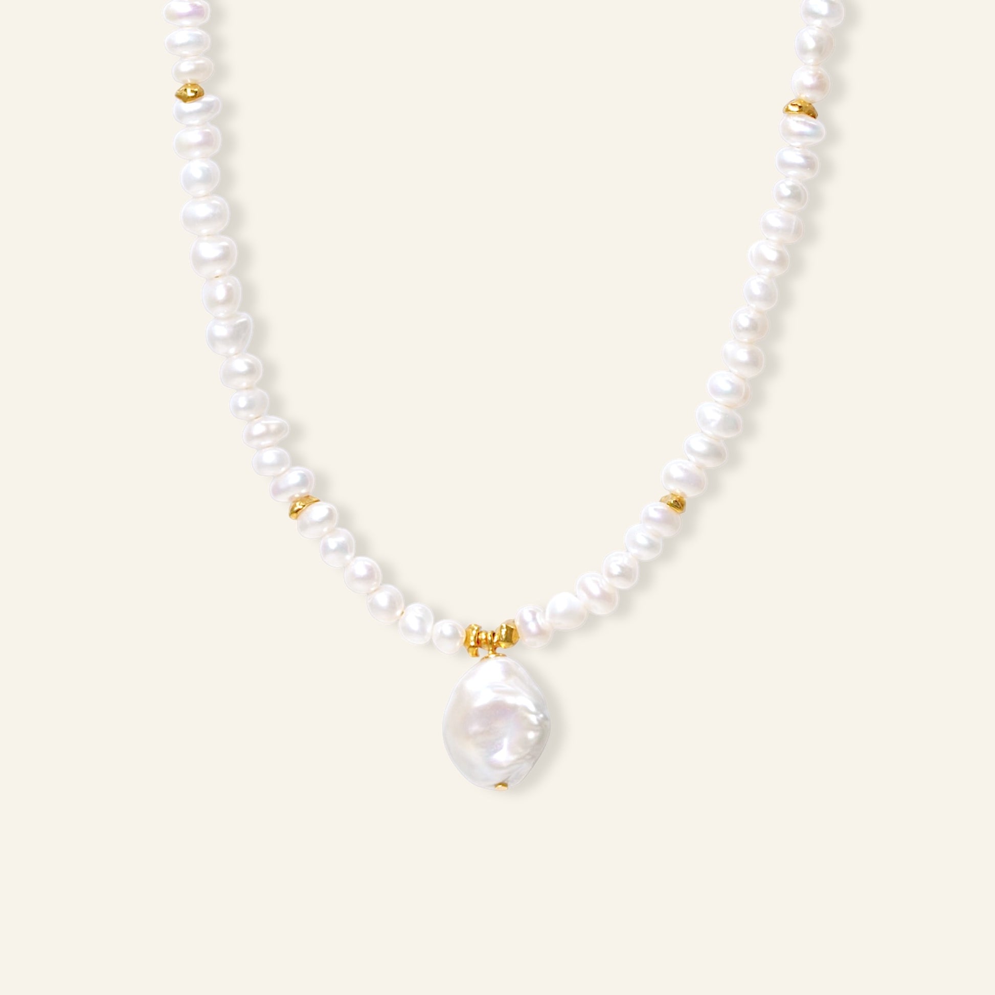 Pearl necklace with gold accents on a white background