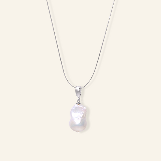 silver necklace with a large irregular white baroque freshwater pearl pendant on a smooth Sterling Silver chain.