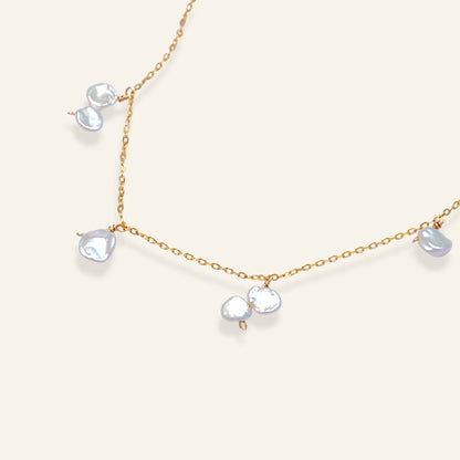 Necklace with pearl-like beads on a gold chain 