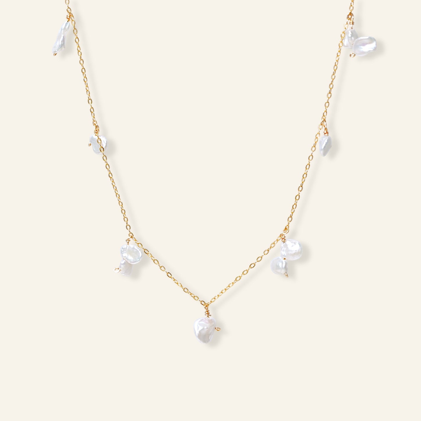 Delicate gold necklace with white pearls 