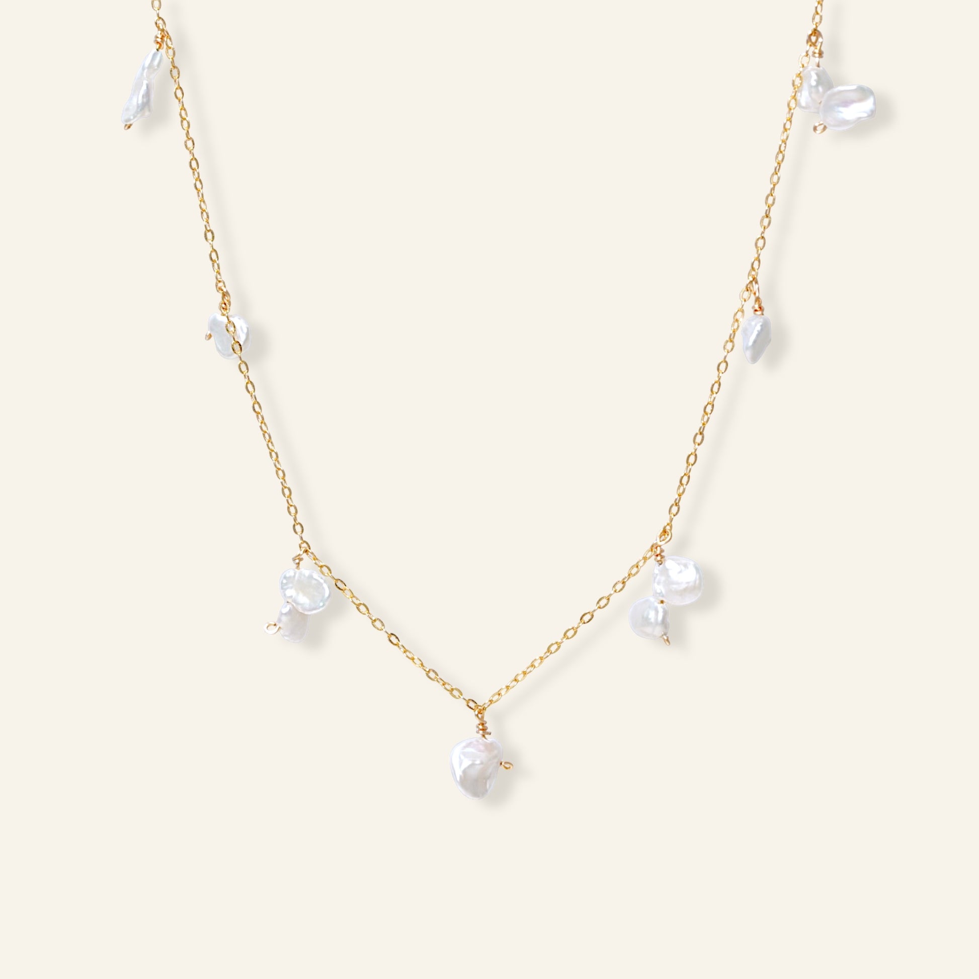 Delicate gold necklace with white pearls 