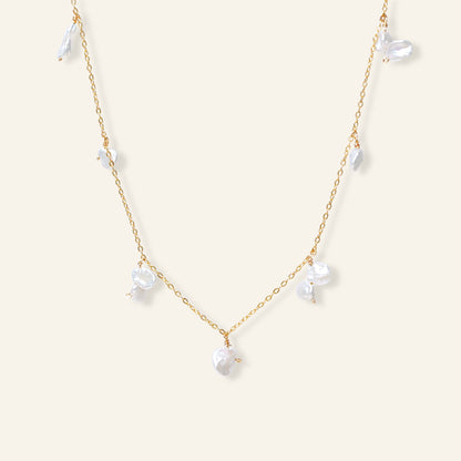 Delicate gold necklace with white pearls 