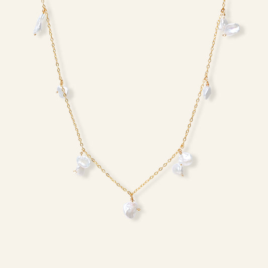 Delicate gold necklace with white pearls 