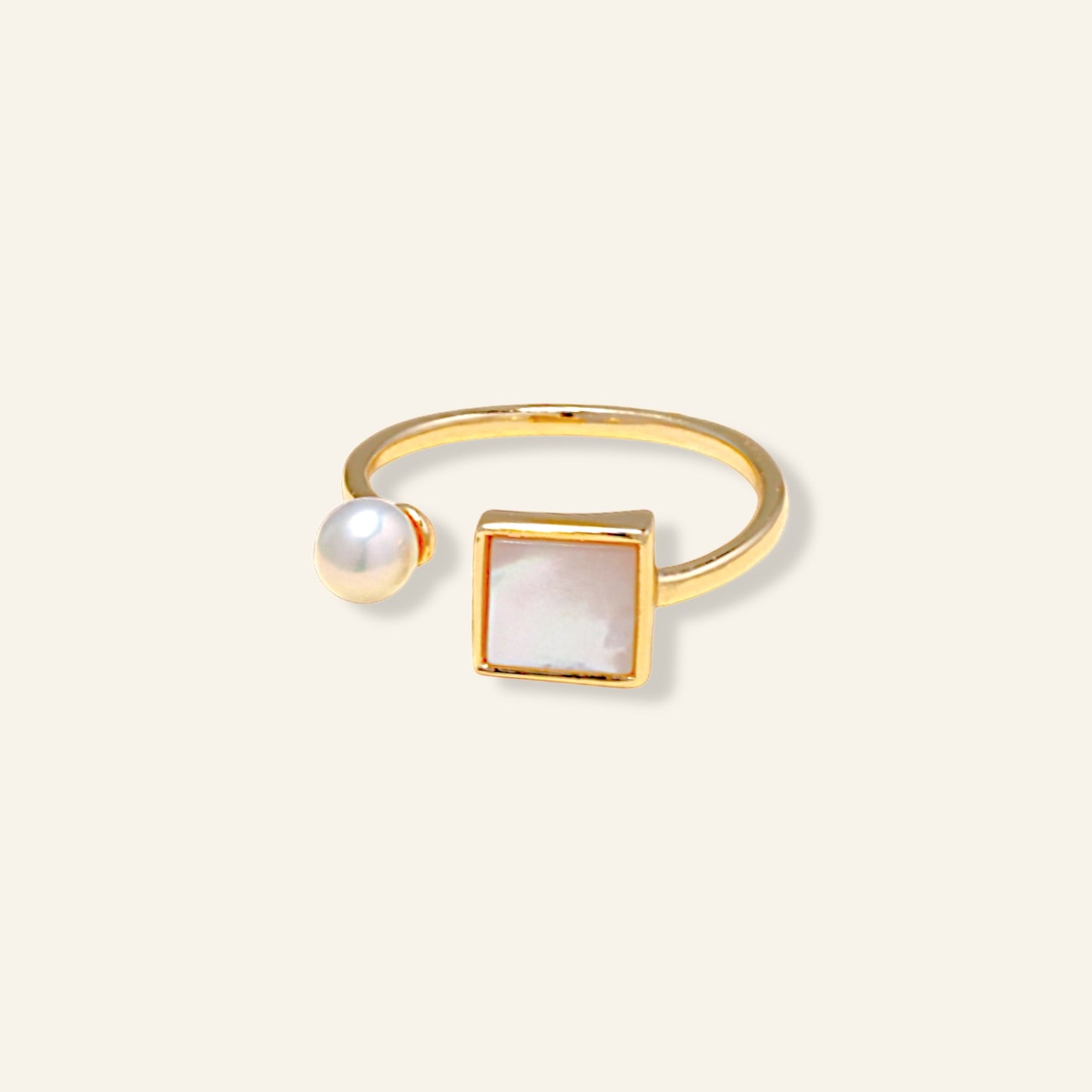 Gold ring with a pearl and square stone 