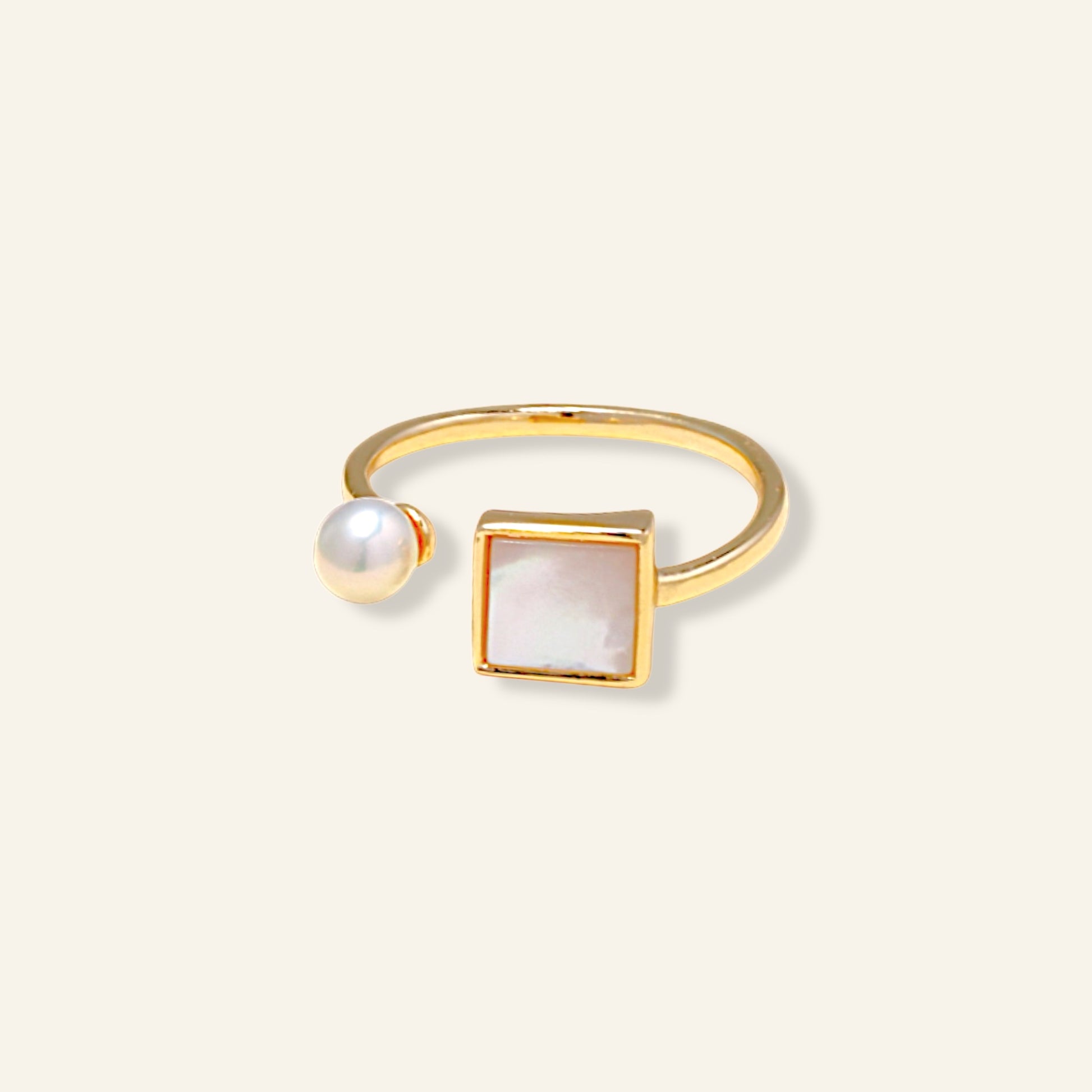 Gold ring with a pearl and square stone 