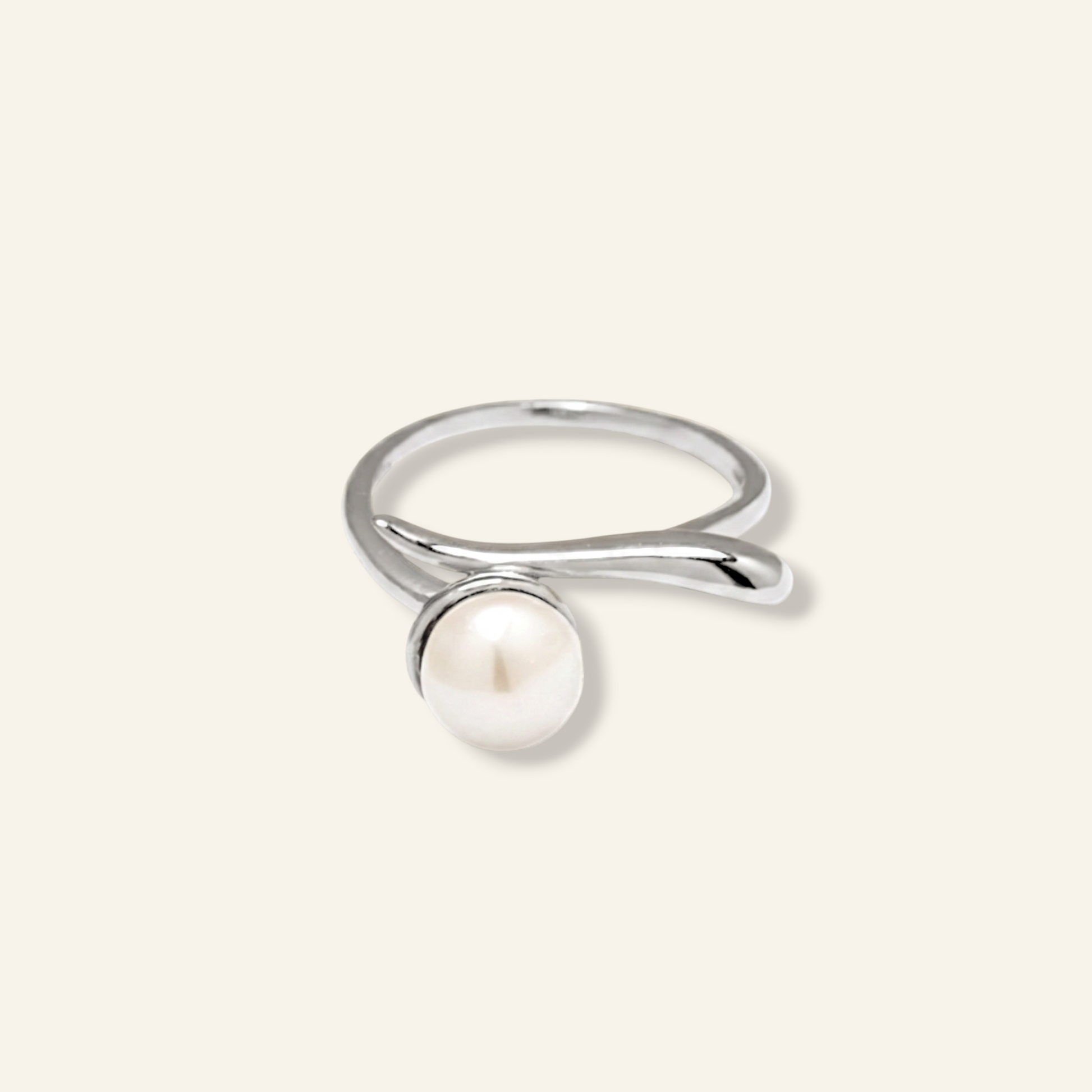 Silver ring with a pearl on a light gray background