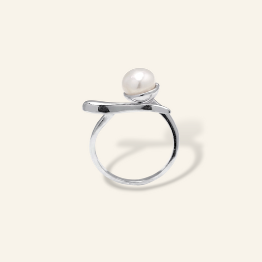 Silver ring with a pearl on a white background